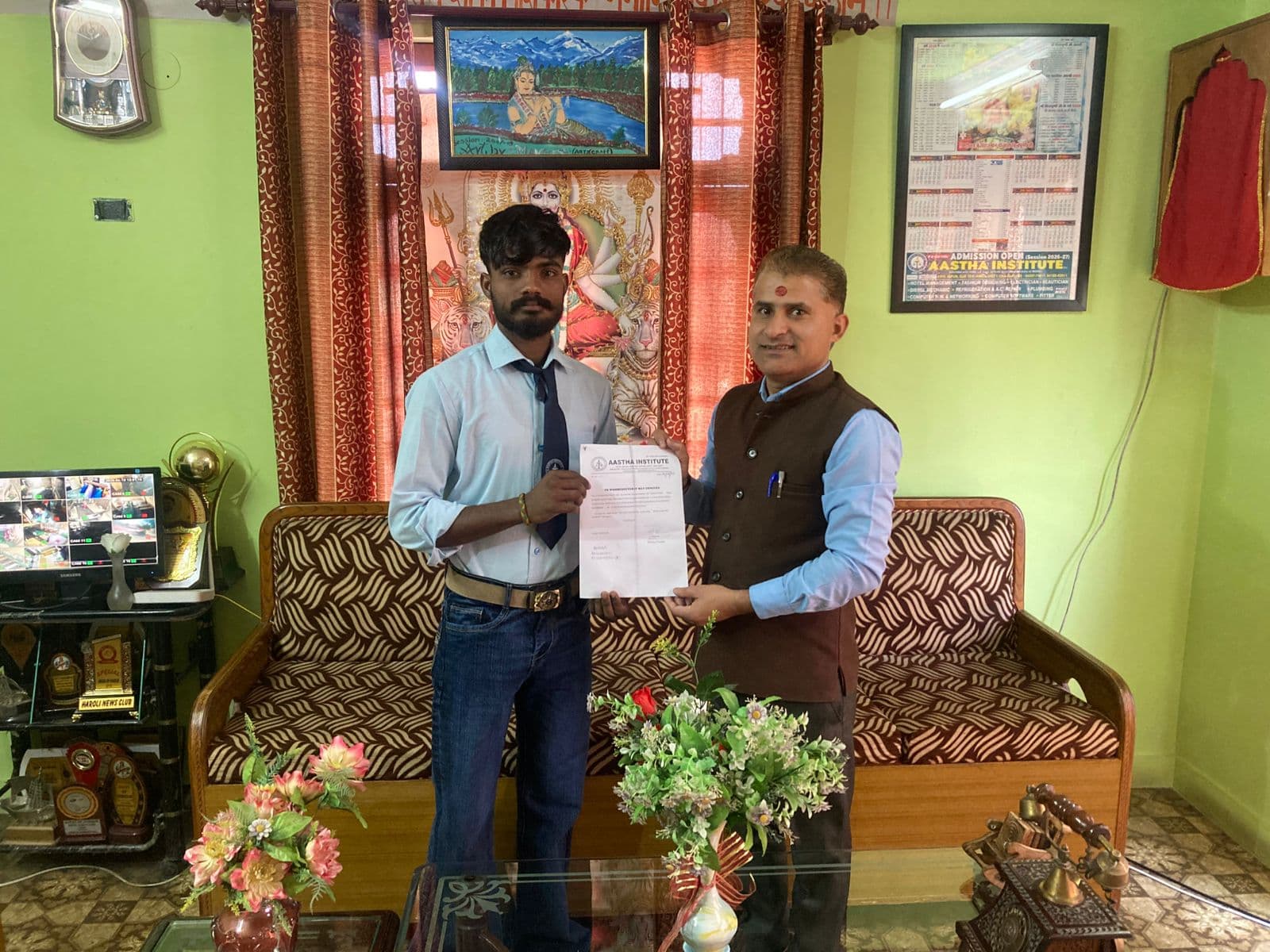 Student receiving certificate at Aastha Institute